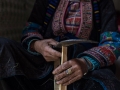 Dao woman cutting bamboo to make incense sticks